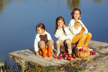 Wall Mural - Kids playing near the lake in autumn