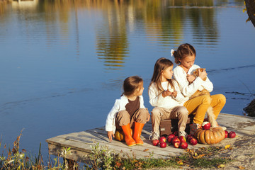 Wall Mural - Kids playing near the lake in autumn