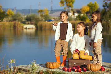 Wall Mural - Kids playing near the lake in autumn