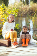 Wall Mural - Kids playing near the lake in autumn