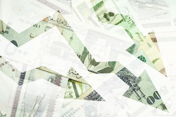 Saudi Arabia money background with negative trends arrows