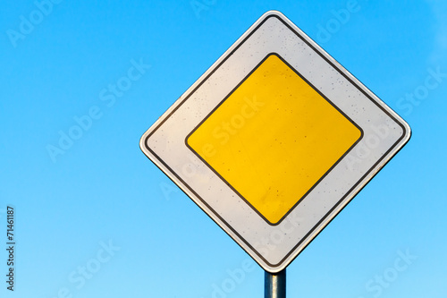 Fotografía Main road yellow roadsign above clear blue sky background