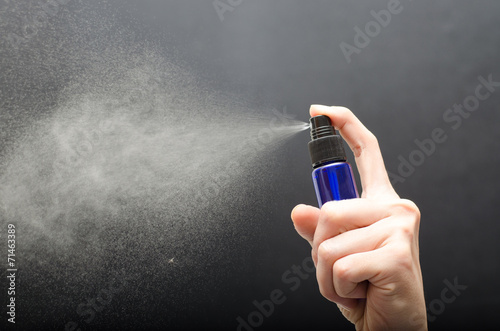 Láminas bottle spraying against gray background