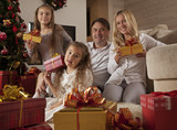 Fototapeta Panele - Happy young family with Christmas gifts