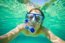 Portrait Of Man Snorkeling In Crystal Clear Laguna Water On Trop