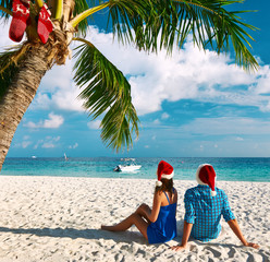 Couple in blue clothes on a beach at christmas