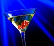 Leinwandbild Motiv red dice in the cocktail glass on blue light casino concept