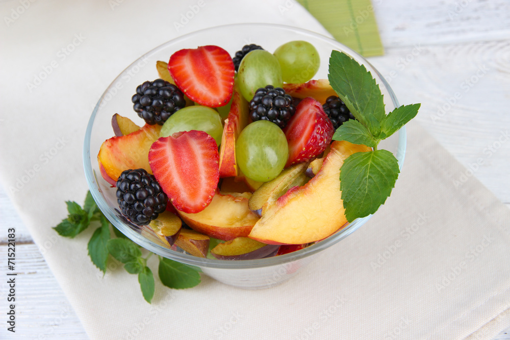 fresh tasty fruit salad on wooden table