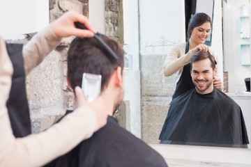 Wall Mural - Handsome man getting his hair trimmed