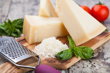 Canvas Print - grated parmesan cheese and metal grater on wooden board