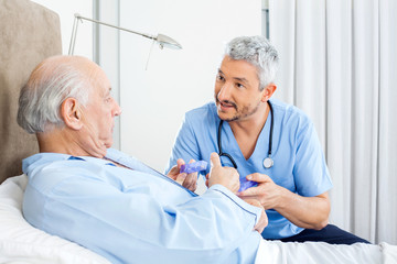 Wall Mural - Caretaker Explaining Prescription To Senior Man