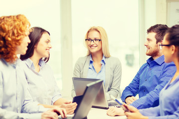 Poster - smiling team with laptop and table pc computers