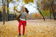 © Andrey_Arkusha - Young woman in fashion coat walking in autumn park