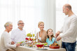 © Syda Productions - smiling family having holiday dinner at home