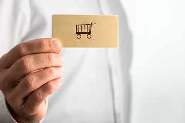 Man holding a business card with a shopping icon