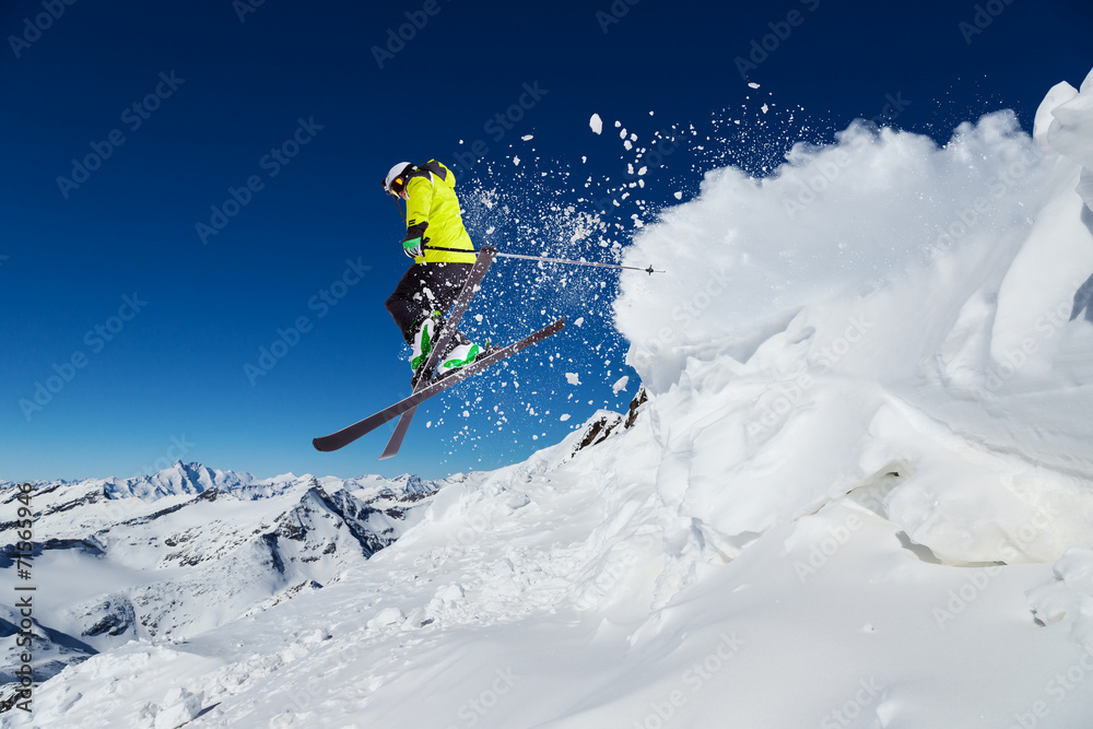 Alpine skier jumping from hill - obrazy, fototapety, plakaty 