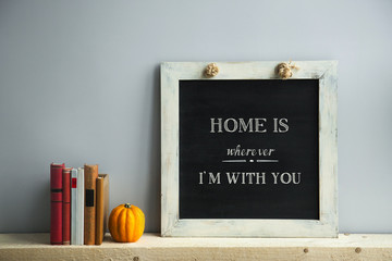 Wall Mural - chalkboard frame on the grey wall with books and pumpkin HOME