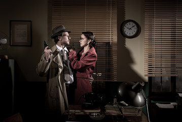 Passionate vintage couple with gun