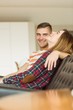 © WavebreakMediaMicro - Cute couple relaxing on couch watching tv