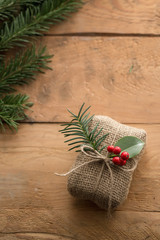Wall Mural - natural holiday wrapped gift with holly berries