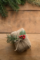 Wall Mural - natural holiday wrapped gift with holly berries