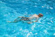 © travelview - teen swims in the pool