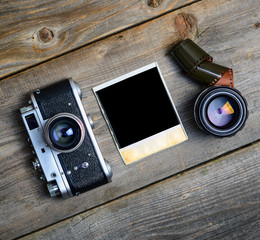 Canvas Print - Vintage camera with lenses and blank old photograph on wooden ba