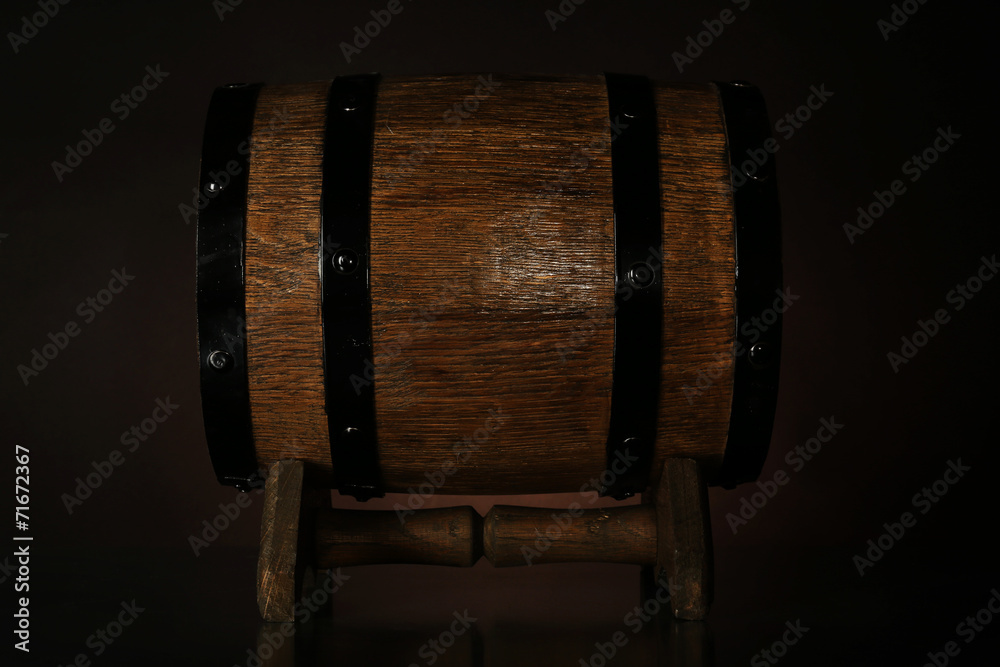 Barrel on wooden table on dark background
