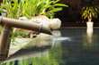 water falling down from bamboo pipe