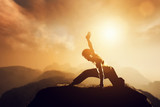 Asian man, fighter practices martial arts in mountains. Sunset