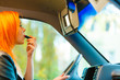 girl painting her lips doing makeup while driving the car.