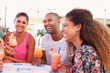 © Monkey Business - Group Of Friends Drinking Cocktails At Outdoor Bar