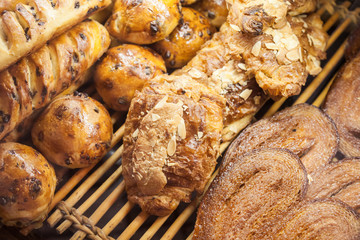 Buns of puff pastry on shelves of French bakery