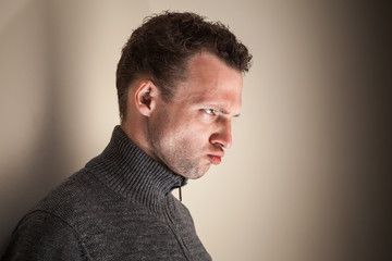 Angry emotional young Caucasian man black and white portrait