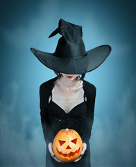 Wall Mural - Mystery witch with Halloween pumpkin