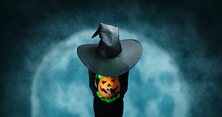 Wall Mural - Mystery Halloween witch with pumpkin