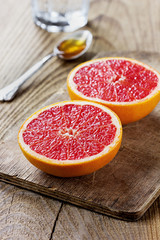 Wall Mural - Grapefruit with honey on a rustic wooden table