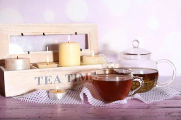 Poster - Composition with tea in cup and teapot and candles