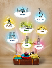 Wall Mural - Tourist suitcase with famous landmarks around the world