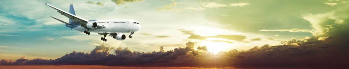 Fototapete - Jet plane in a spectacular sunset sky