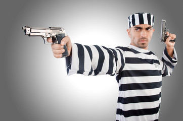 Prisoner with gun isolated on white