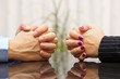 Man and woman sits at a desk with hands clasped. marital problem