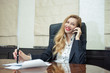 Portrait of happy modern business woman talking phone