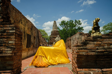 statue at reclining buddha in Wat Puthai Sawam Thailand