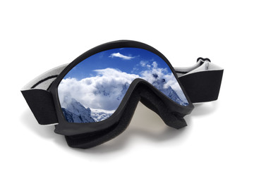 Ski goggles with reflection of snowy mountains