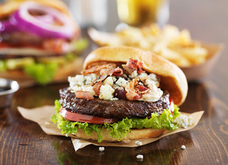 Sticker - gourmet burgers on wooden table with bleu cheese and bacon