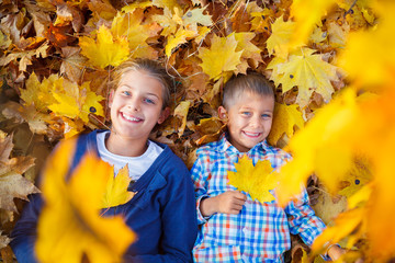 Cute boy and girl in autumn park