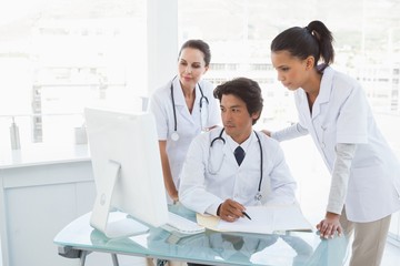 Wall Mural - Doctors looking at a computer