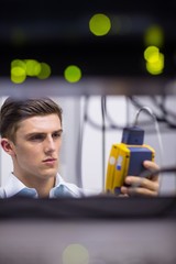 Poster - Serious technician using digital cable analyzer on server