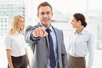 Poster - Businessman with colleagues behind at office